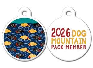 Dog tag with a picture of dogs in a field on one side and "2026 Dog Mountain Pack Member" on the other