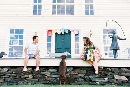 A couple and their dog sitting outside the front doors at the Stephen Huneck Gallery