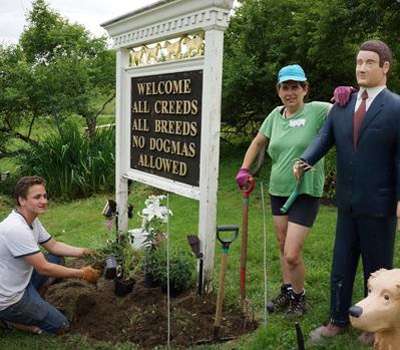 Volunteers planting a garden under the Dog Chapel sign