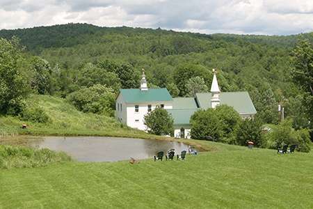 A view of the pond and buildings at Dog Mountain