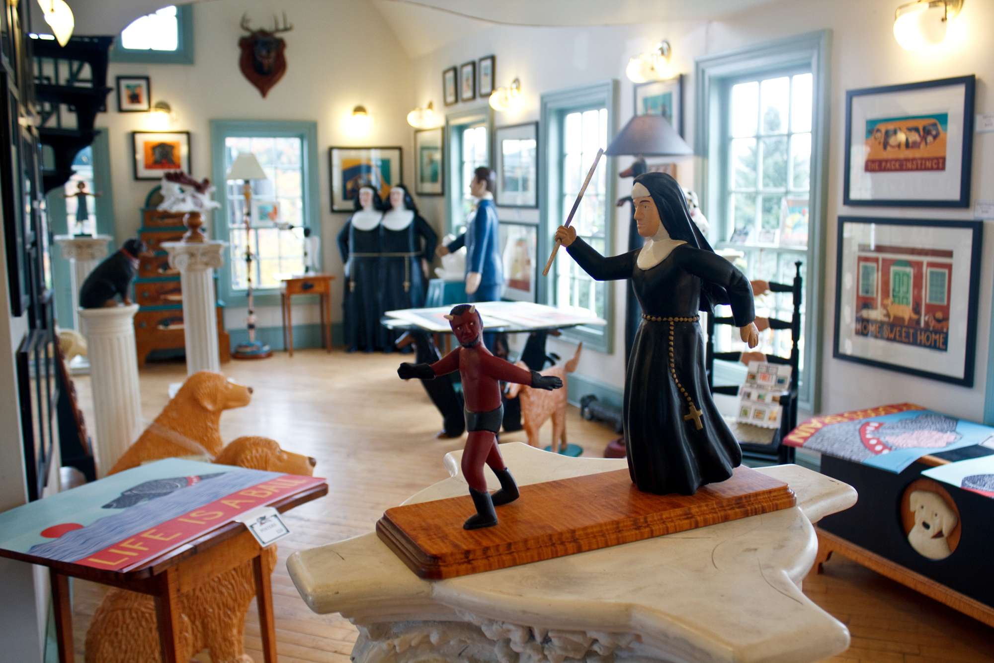 Stephen Huneck Gallery nun chasing devil sculpture
