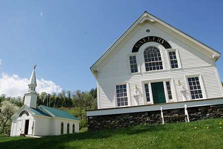The front fo the Huneck art gallery with the dog chapel in the background